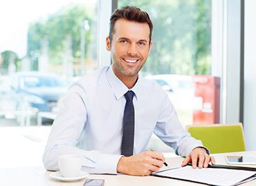 person11 Independent travel agent working from a laptop at home, reviewing client bookings